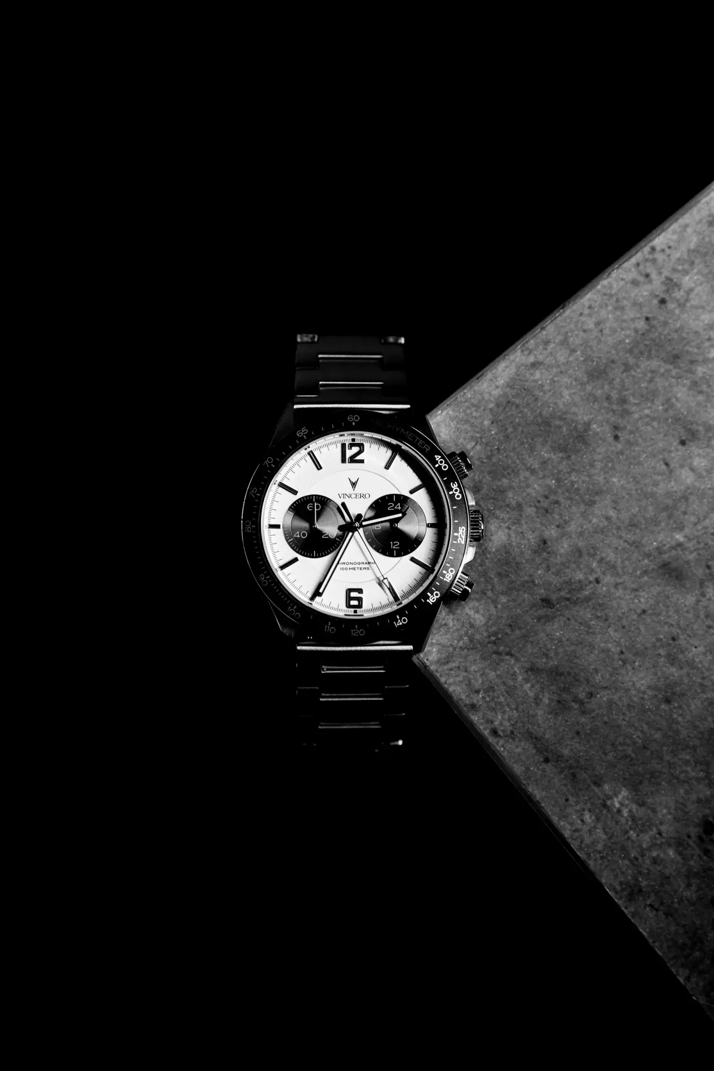 A chronograph watch on a black surface
